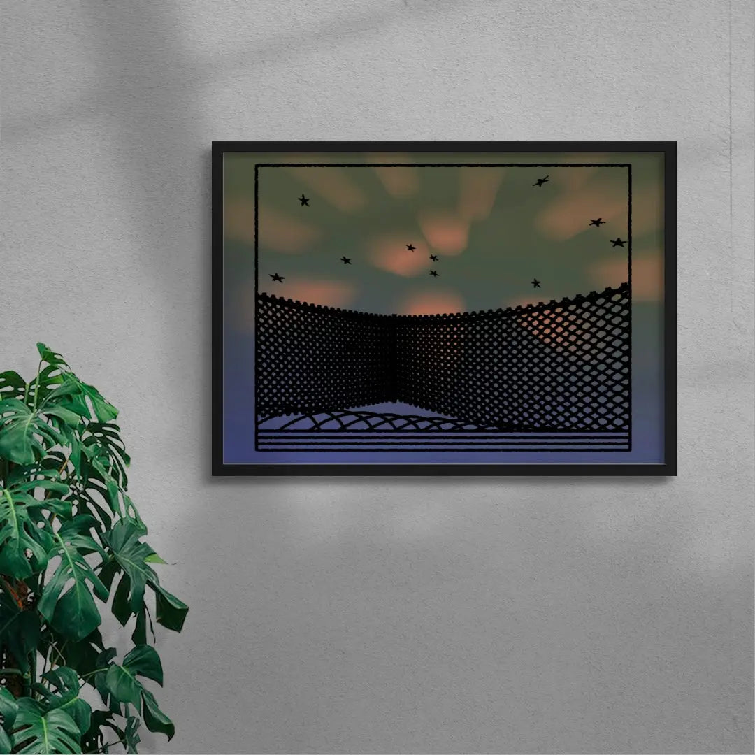 Framed artwork of a geometric design with birds against a sunset sky, on a gray wall with a plant to the left.