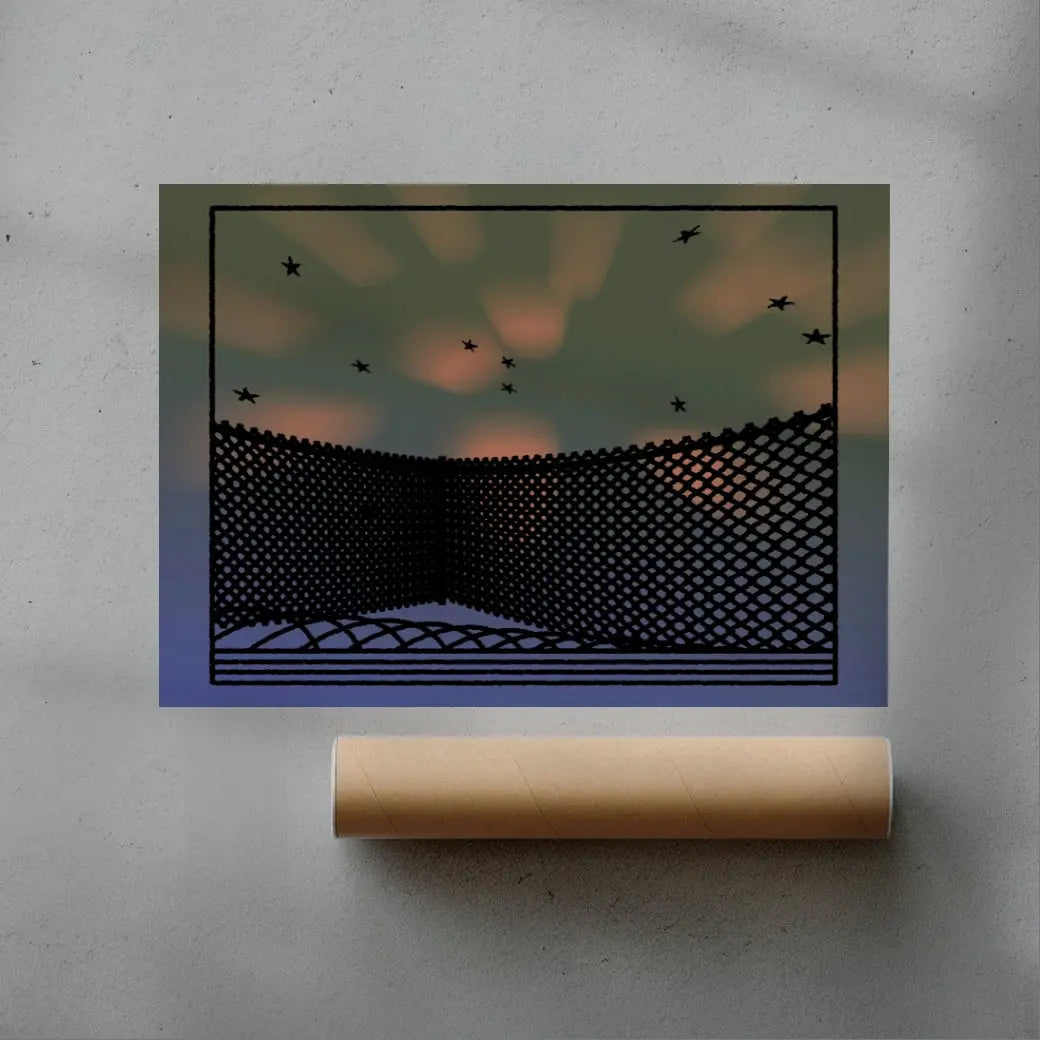 Art print of a black wire fence with birds against a blurred sunset sky, displayed on a gray surface with a roll of paper.