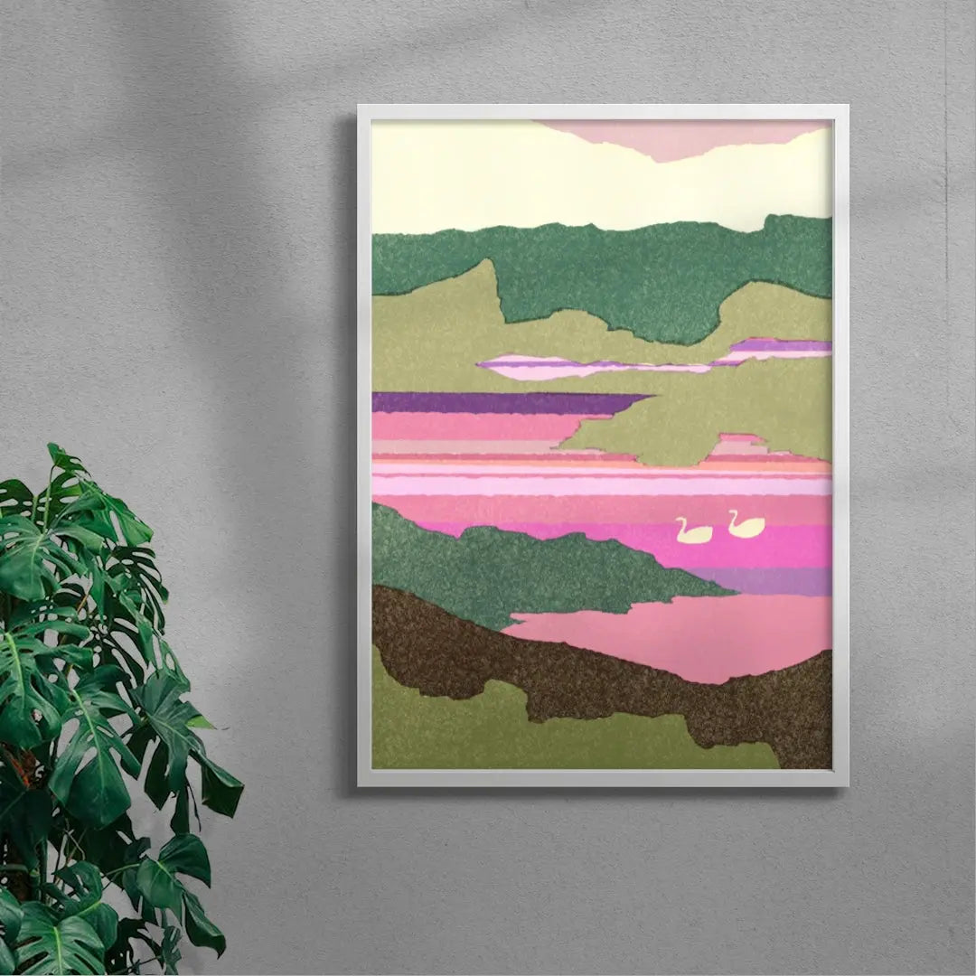 Framed abstract landscape art on a gray wall with a plant to the left.