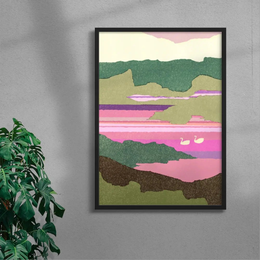 Framed abstract landscape art on a gray wall with a plant to the left.