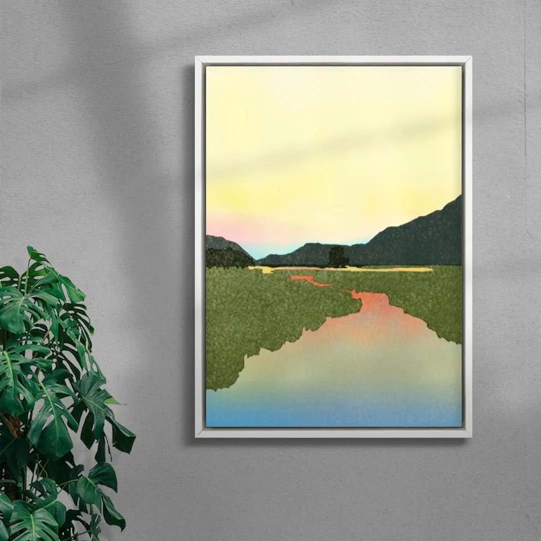 Framed artwork of a landscape with mountains and a lake on a gray wall.