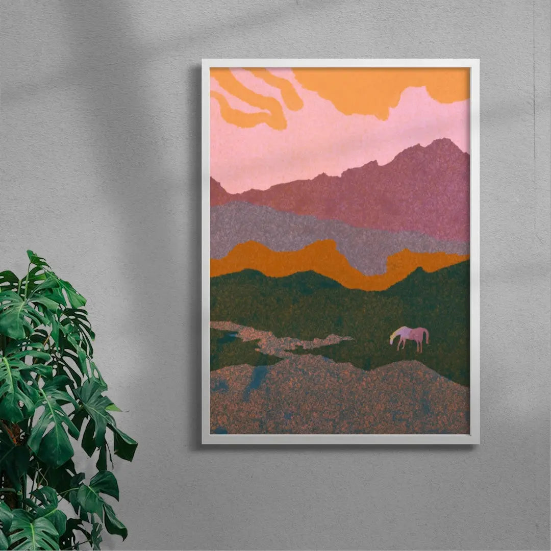 Framed abstract landscape art on a gray wall with a plant to the left.
